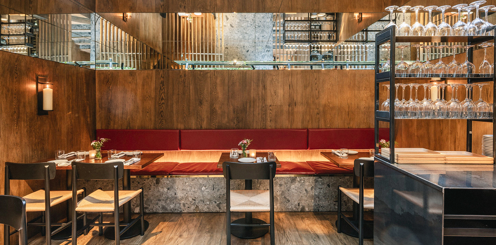 Contemporary gastro bar interior design with cast-iron shelving and open kitchen.