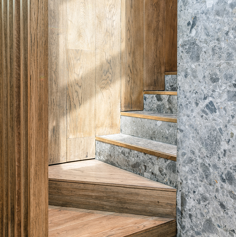 Staircase with Ceppo di Gre stone stairs and solid oak walls.