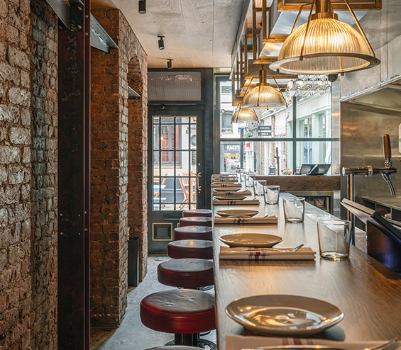 Long bar table with stools in a contemporary gastro bar.