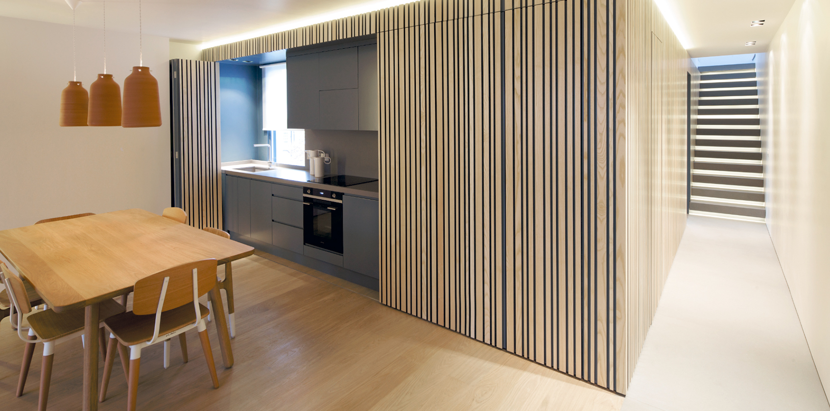 Contemporary open plan kitchen with a dining area.