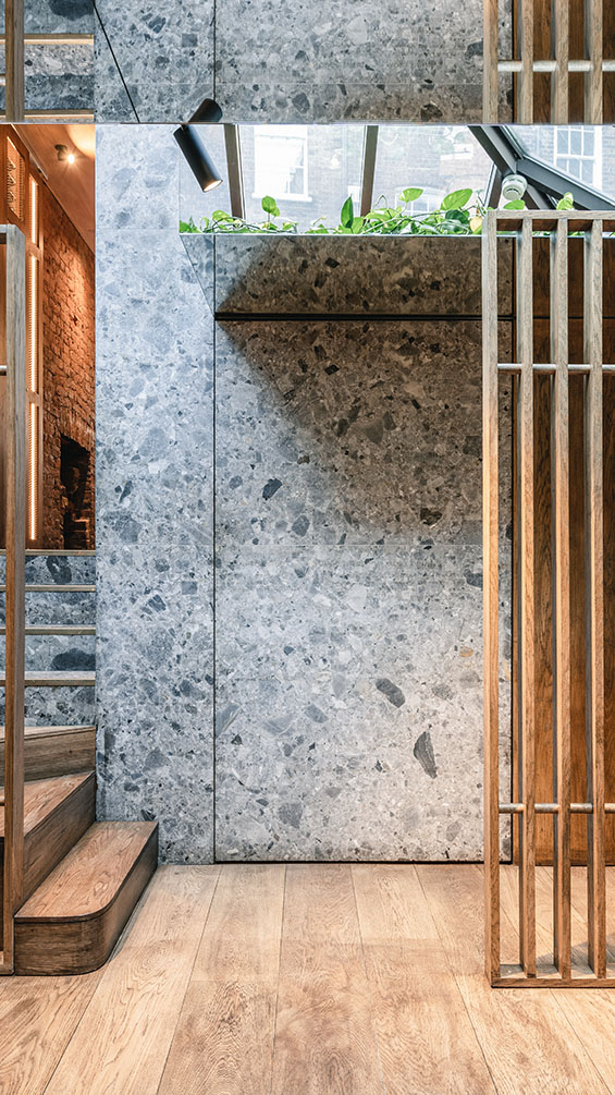 Contemporary stairs with Ceppo di Gre stone walls.