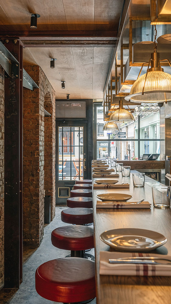 Long bar table with stools in a contemporary gastro bar.