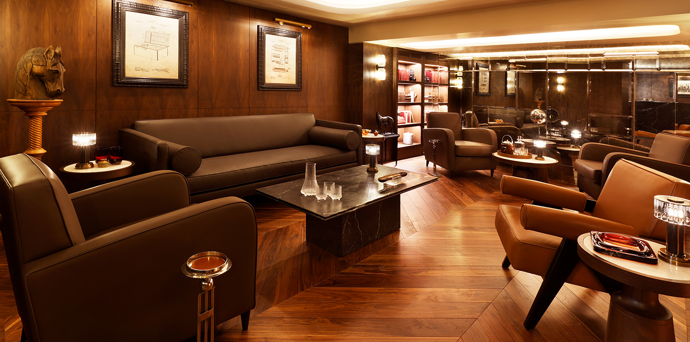 Luxury cigar lounge with leather furniture and timber elements.