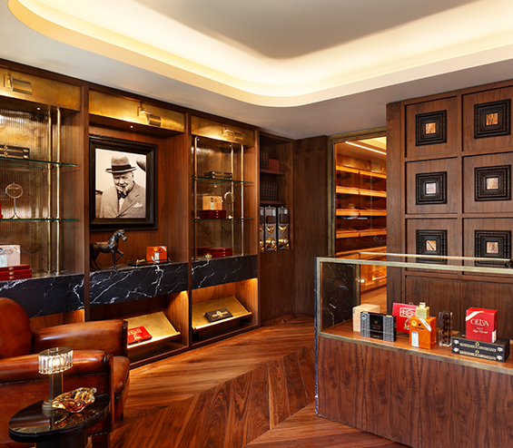 Luxury cigar lounge bespoke timber and glass shelving unit with Winston Churchill photograph.