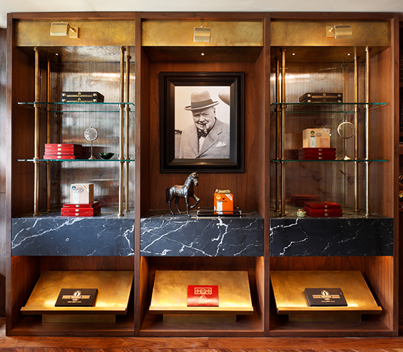 Luxury cigar lounge bespoke timber and glass shelving unit with Winston Churchill photograph.