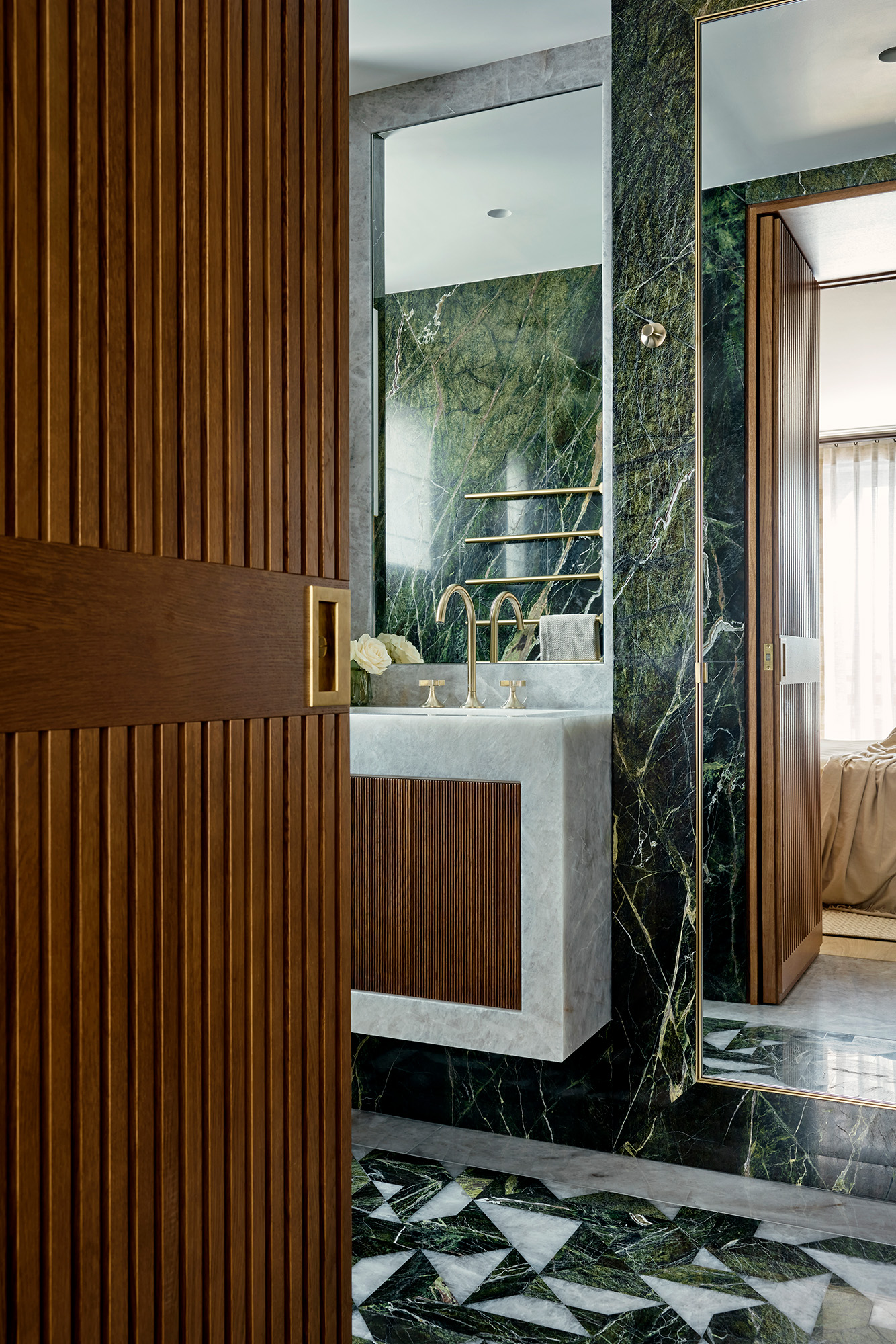 Luxury en suite bathroom with brass and marble features.