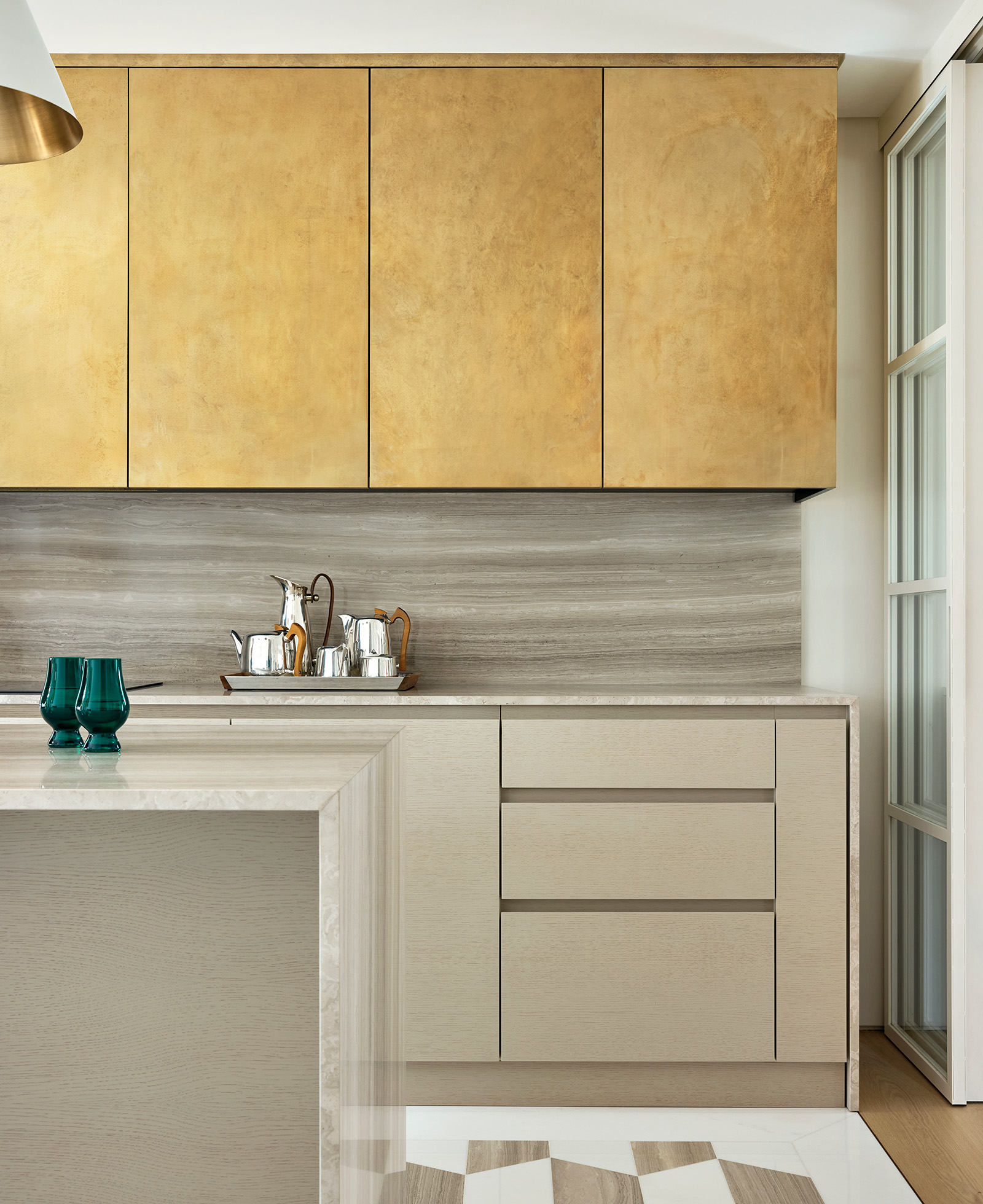 Bespoke kitchen with silver travertine cabinetry.