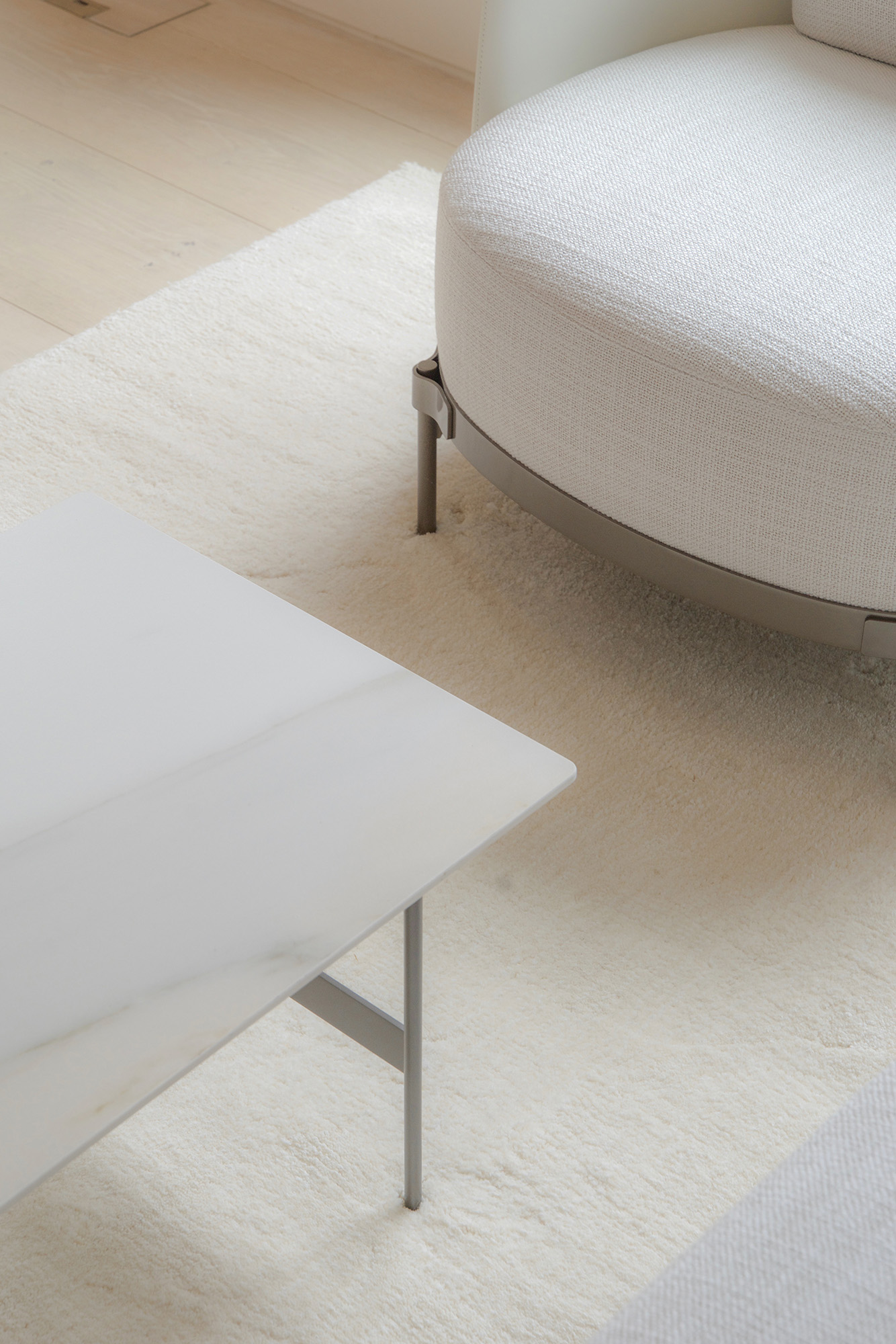 Bespoke armchair and white marble coffee table on a white cream rug.